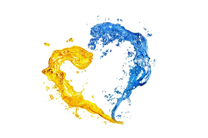 Heart from yellow and blue water splashes with bubbles isolated on white backround. National ukranian colors, stand with Ukraine